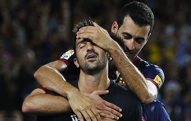 David Villa celebrates with team mates against Real Sociedad