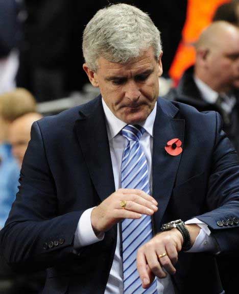 Mark Hughes looks at his watch as he realizes time is running out.