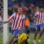 Atletico Madrid thrashed Sevilla 4-0 to draw level with Barcelona at the top of La Liga