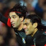 Turan celebrates his goal with Radamel Falcao