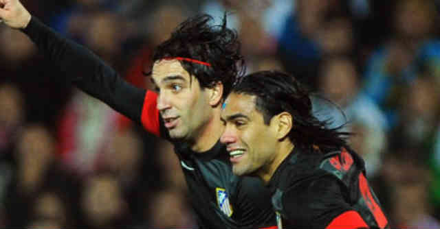 Turan celebrates his goal with Radamel Falcao
