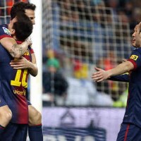 Cesc Fabregas celebrates his goal with Lionel Messi against Malaga