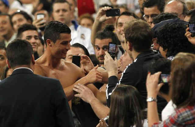 Cristiano Ronaldo celebrates with his fans by giving his Jersey to his fan