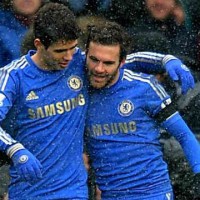 Mata celebrates his goal with Oscar as Chelsea managed to keep their win to the end against Arsenal