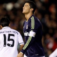 Real Madrid's Cristiano Ronaldo, centre, reacts after failing to score against Valencia during their Copa del Rey match in Valencia,