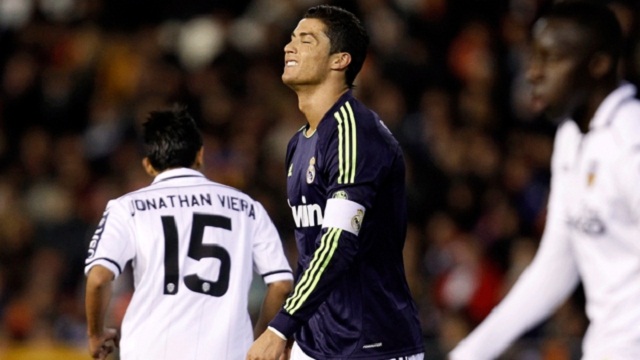 Real Madrid's Cristiano Ronaldo, centre, reacts after failing to score against Valencia during their Copa del Rey match in Valencia,