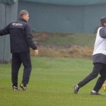 The young Italian striker Mario Balotelli is dragged away by a member of City's coaching staff.