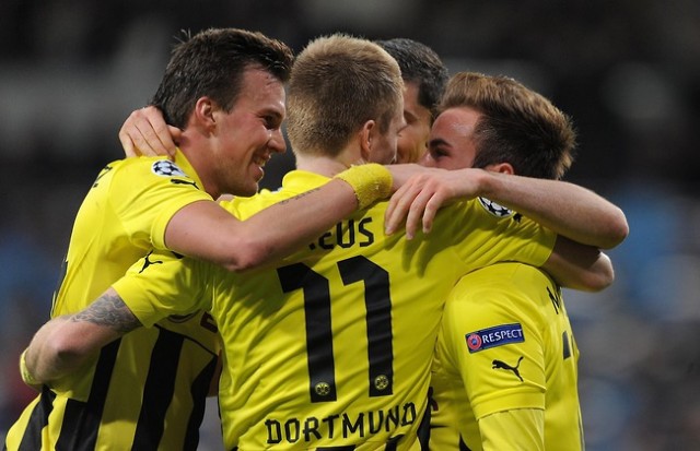 Borussia Dortmund claimed a 2-2 draw at Shakhtar Donetsk to take a big step toward the Champions League quarter-finals on Wednesday.