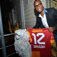 Drogba holding his Jersey and would be playing in the Champions League again
