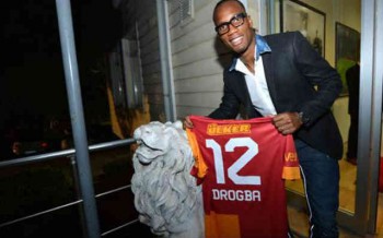 Drogba holding his Jersey and would be playing in the Champions League again