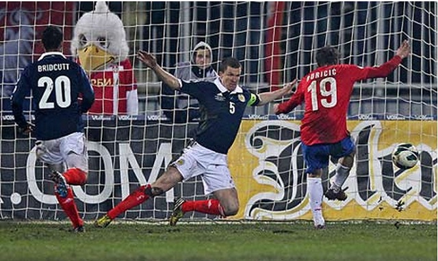 Filip Djuricic, right, scores Serbia's opening goal after Scotland's defence failed to deal with a low cross into the box. 