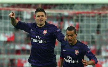 Olivier Giroud celebrates his goal with Theo Walcott but beleives the Gunners are rising