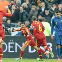 Sergio Busquets celebrates his goal while Raphael Varane upset with the lose