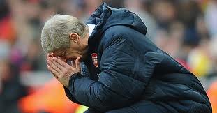 Arsenal Manager, Arsene Wenger holding his head in despair