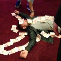 Bardsley appeared to enjoy his winnings a touch too enthusiastically though, and was pictured lying down before friends covered him in banknotes