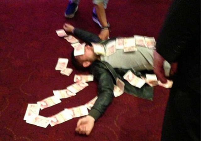 Bardsley appeared to enjoy his winnings a touch too enthusiastically though, and was pictured lying down before friends covered him in banknotes