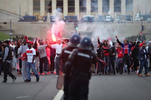 Paris Saint-Germain's celebration of its first French league 1 title since 1994 is marred by clashes between riot police and fans in the shadow of the Eiffel Tower.