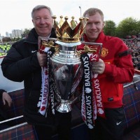 Paul Scholes and Sir Alex Ferguson exhibiting the English Premier League trophy 2013