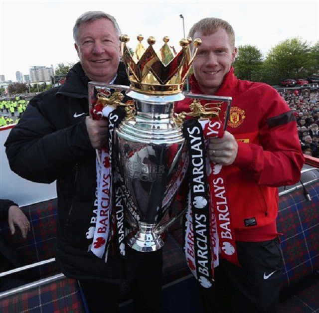 Paul Scholes and Sir Alex Ferguson exhibiting the English Premier League trophy 2013