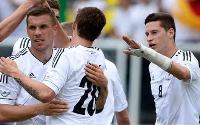 Podolski celebrates his goal with his team mates