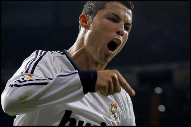 Real Madrid's Cristiano Ronaldo celebrates after scoring during a Spanish La Liga football match against Malaga's at the Santiago Bernabeu 