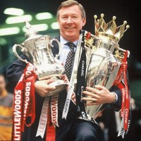 Sir Alex Ferguson with an armful of trophies