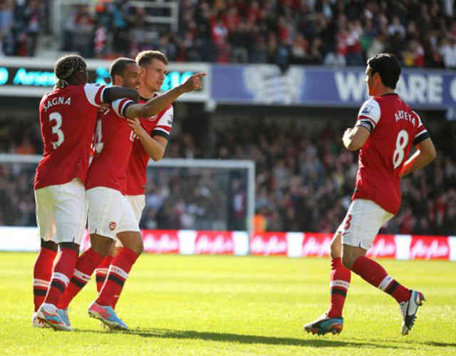 Theo Walcott celebrates with his team for his goal