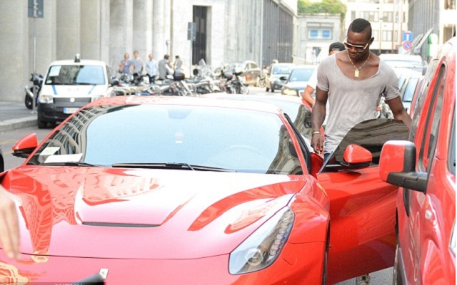 Balotelli in his new car, a red Ferrari F12 Berlinetta, going on a shopping spree in Milan.