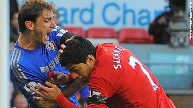 This is the moment when Luis Suarez bites Ivanovic's arm during a football game against Chelsea