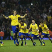 Arsenal celebrate as they take it in penalties