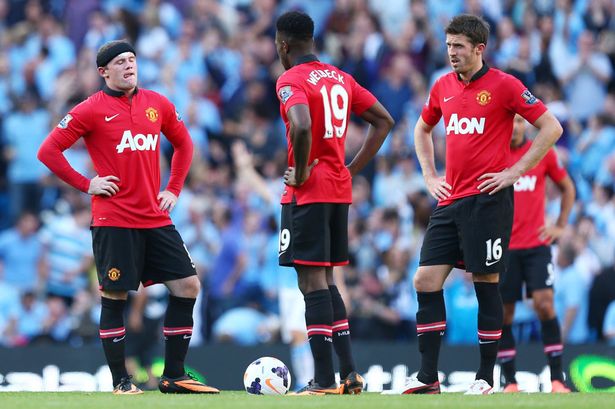 Manchester United players dejected in loss to neighbours City.