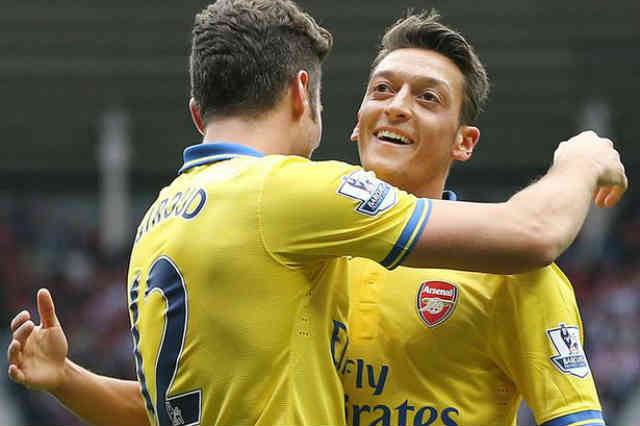 Ozil celebrates with Giroud with the assist he gives