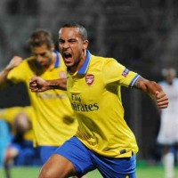 Theo Walcott celebrates his smashing goal in Marseille