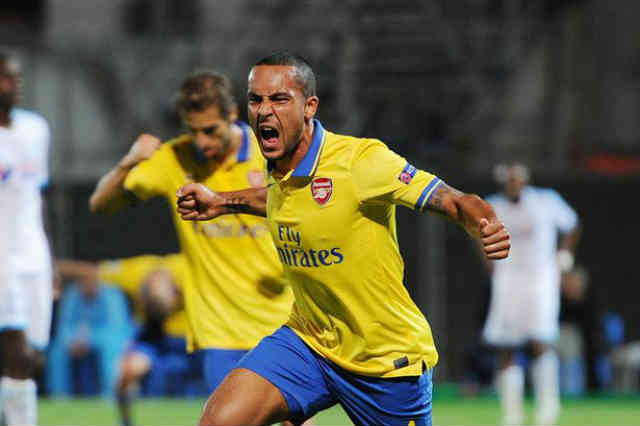 Theo Walcott celebrates his smashing goal in Marseille