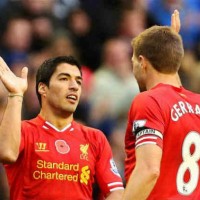 Suarez celebrates with his team mate Gerrard