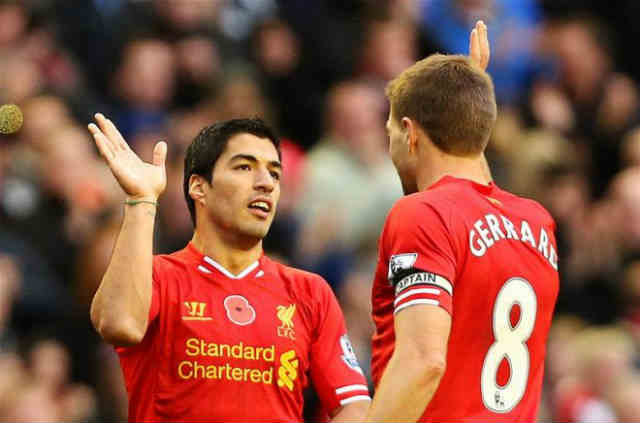 Suarez celebrates with his team mate Gerrard