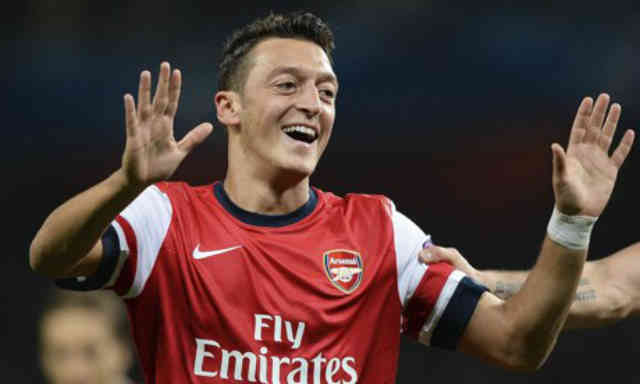 Mesut Ozil is happy to be with the Gunners